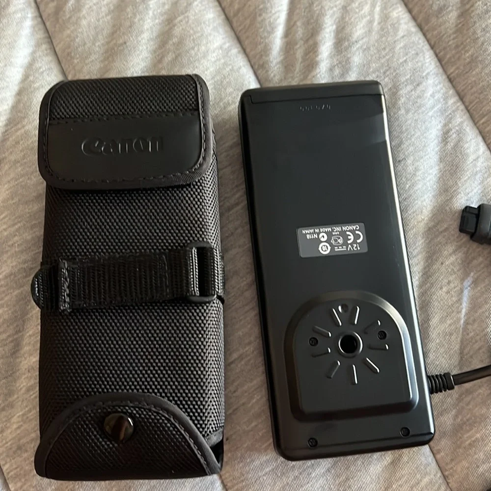 Canon batter pack with case and camera frame with flashgun cable